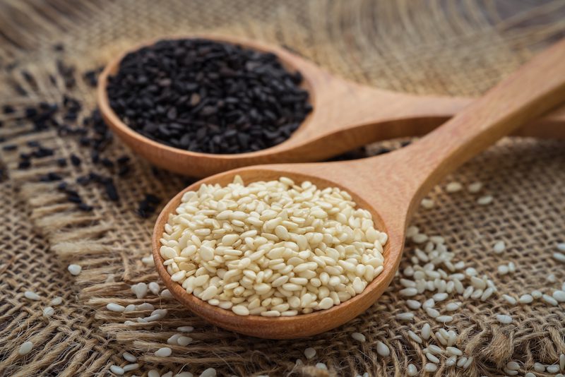 |White sesame and black sesame seed on wooden spoon|White sesame and black sesame seed on wooden spoon